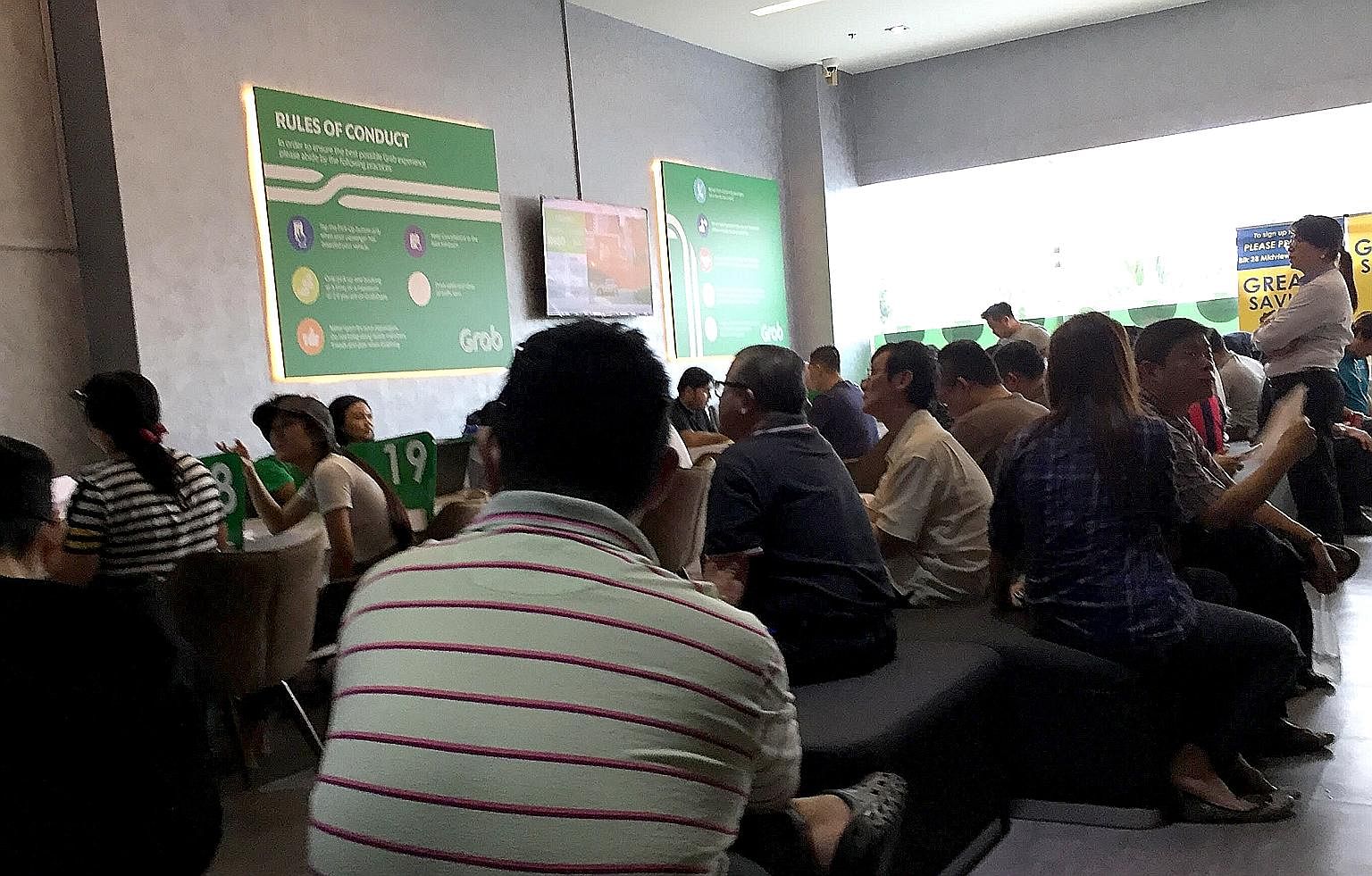 Grab's office in Sin Ming Lane was packed yesterday afternoon with many Comfort and CityCab drivers. At about 2.50pm, the queue number was 473.