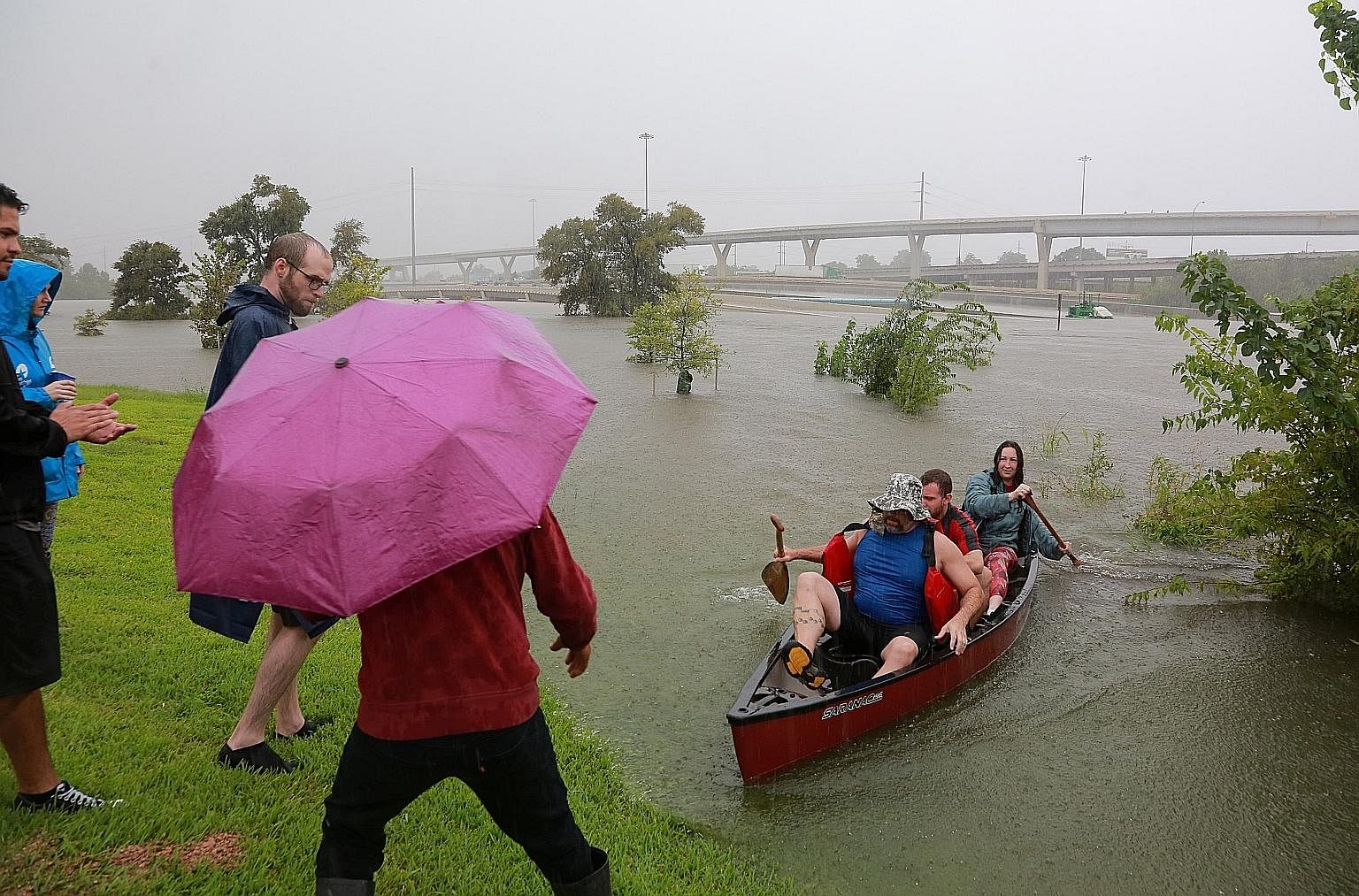 Residents using a kayak to rescue motorists stranded on a highway that was submerged amid widespread flooding caused by Hurricane Harvey last month in Houston, Texas. It took a flooding crisis, says the writer, to join people into one interconnected,
