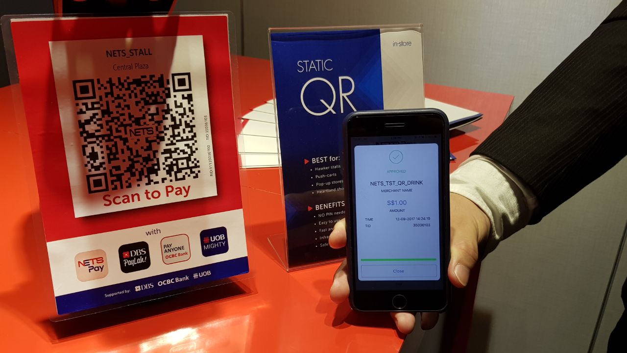 Pay with Nets app on a phone from October; more QR code payment, tap ...