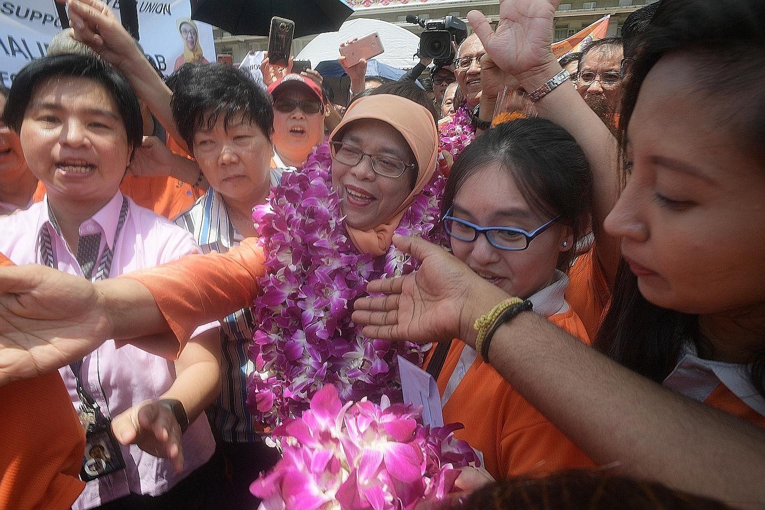 Madam Halimah Yacob greeting supporters at the PA Headquarters yesterday, where she was declared President-elect in a walkover at around noon. Prime Minister Lee Hsien Loong said she brings to the presidency her experience of working with Singaporean