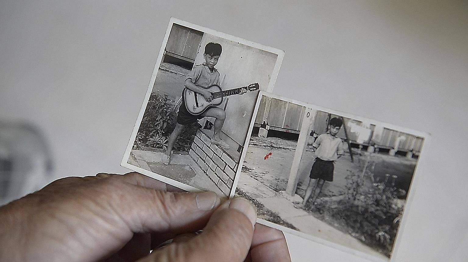 Above: Mr Thio Sin Nam in his early teens at a Paya Lebar work camp, where he did odd jobs. Left: Identity cards for Mr Thio Sin Nam's father Thio Kum Choon and mother Lam Ah Hup (pictured with a young Mr Thio).