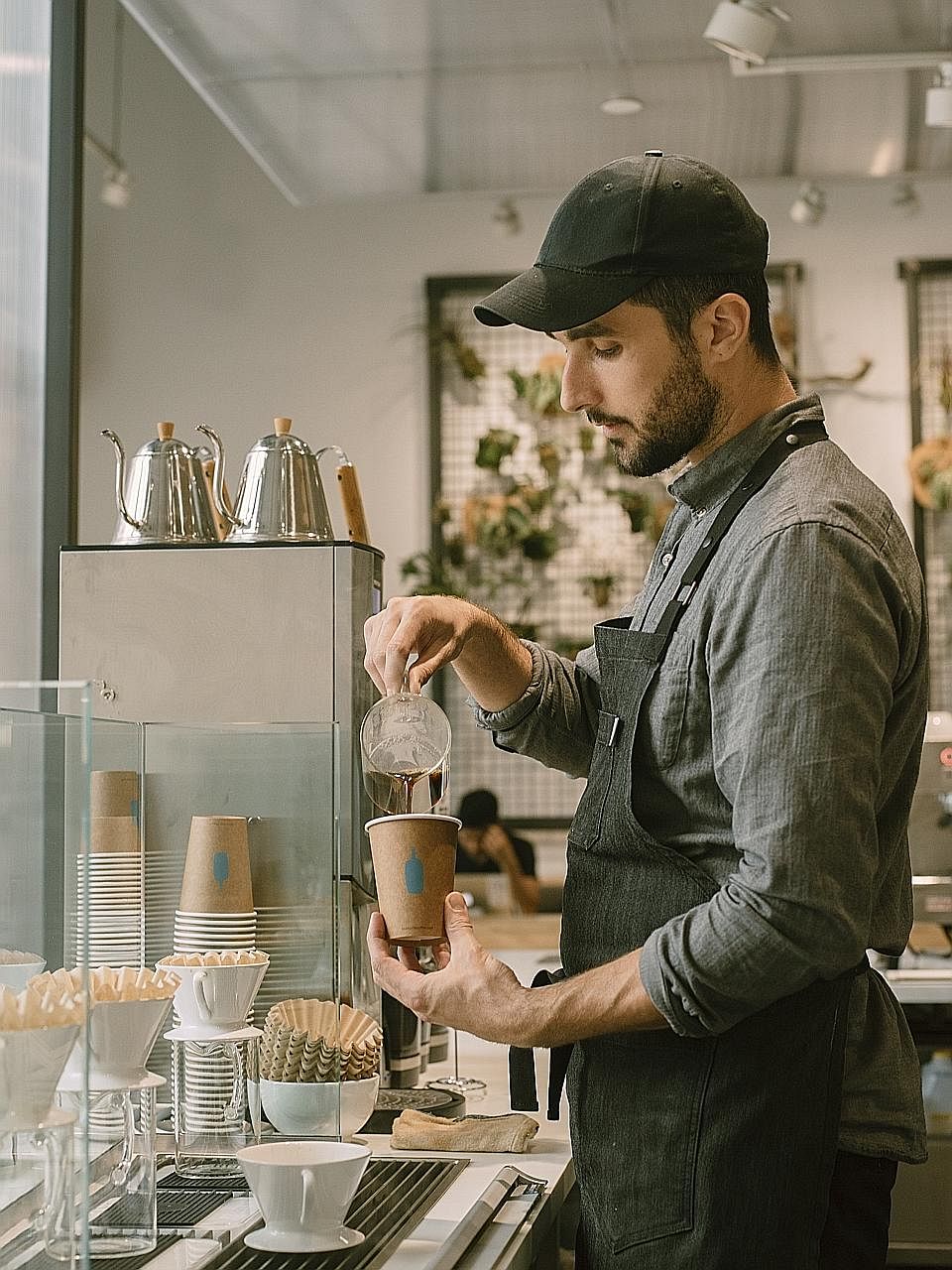 A Blue Bottle Coffee shop in the Bushwick neighbourhood of Brooklyn. Blue Bottle announced on Thursday that it had sold a majority stake to Nestle, one of the surest signs yet of how so-called third-wave speciality coffee has become a hot business.