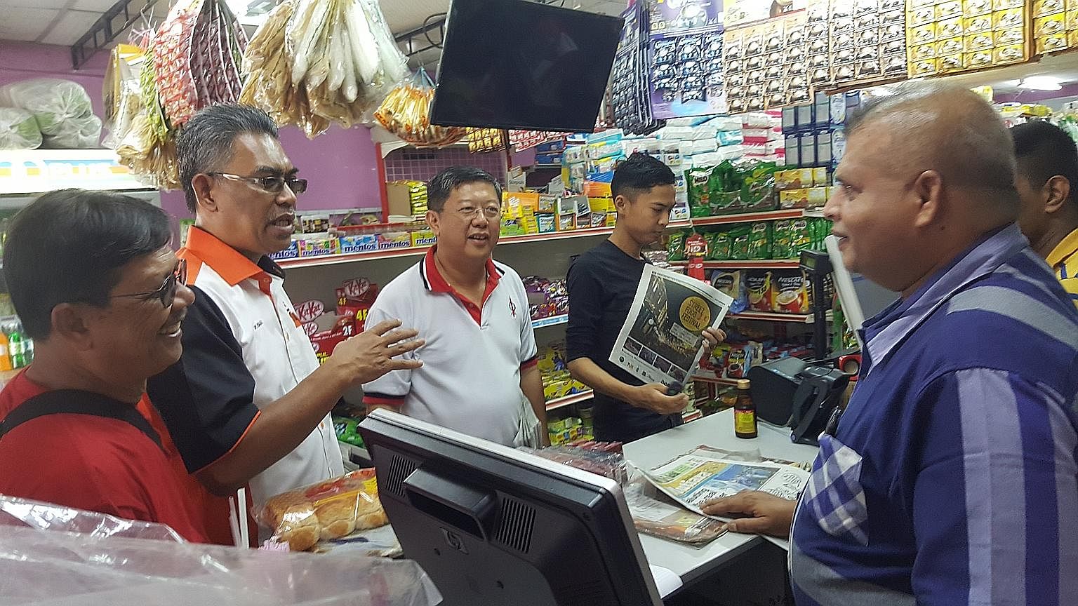 Kedah Amanah chief Ismail Salleh speaking with residents as he and DAP assemblyman Tan Kok Yew work the ground in Ayer Hitam in Kedah. Their Pakatan Harapan alliance is going all out to break the ruling coalition's grip in state strongholds, hoping t