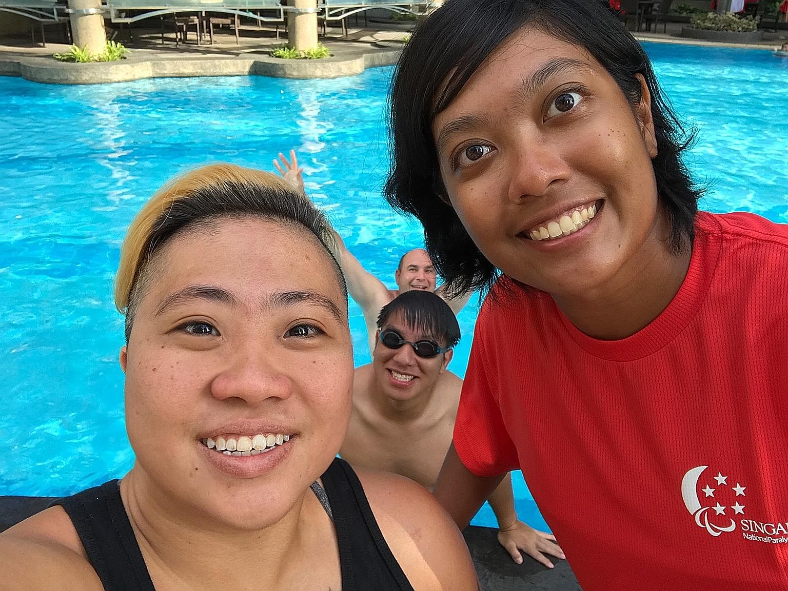 Paralympic swimmer Theresa Goh and para-archer Nur Syahidah Alim chilling out at the pool at the Asean Para Games in Kuala Lumpur.