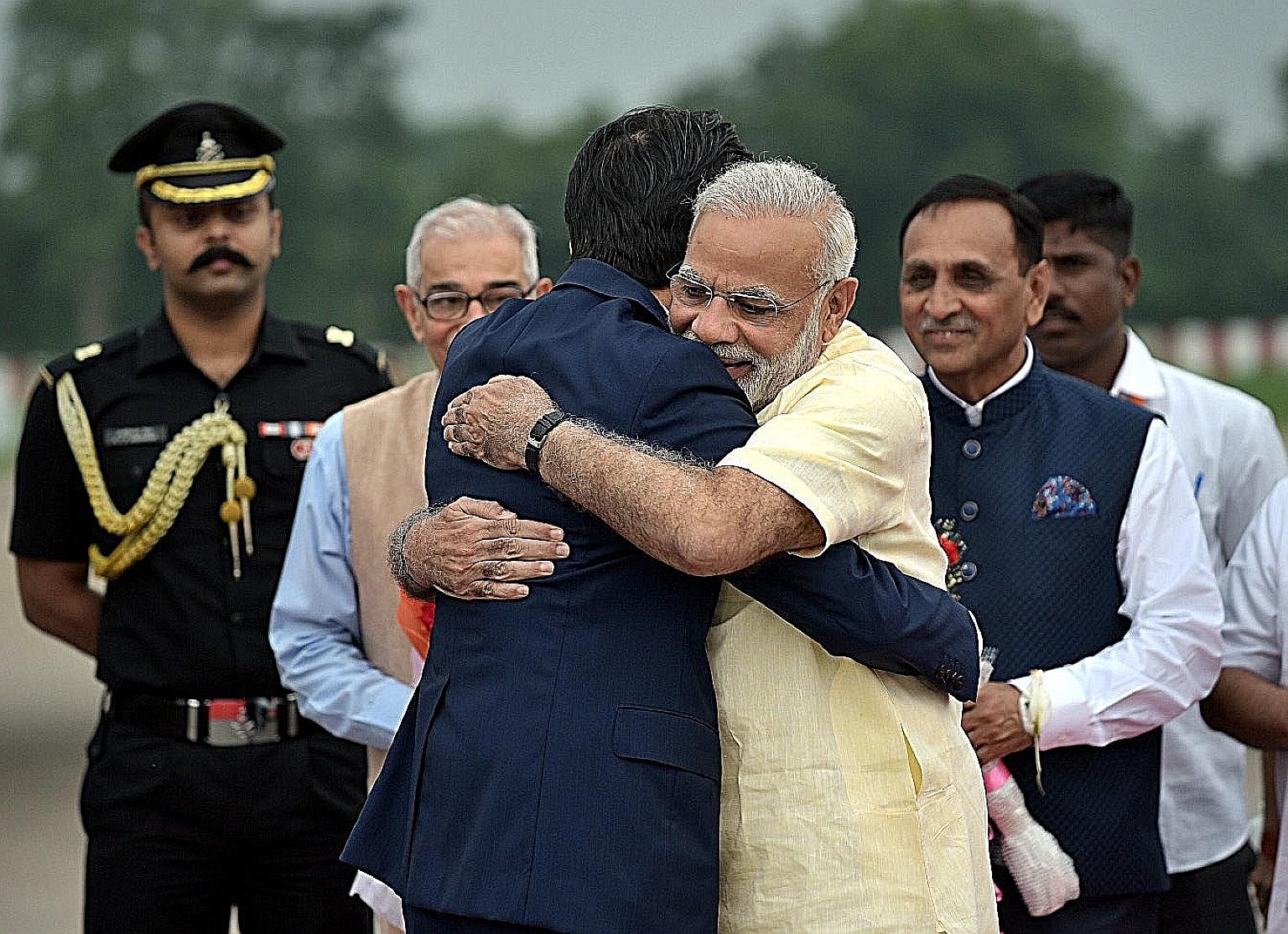 Mr Narendra Modi and Mr Shinzo Abe sharing a bear hug in Gujarat last week - a sign of warm relations between their two countries.