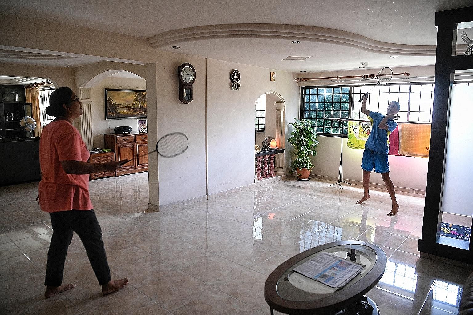 Mrs Indra Rajen in the family's jumbo flat in Yishun, which is spacious enough for a game of badminton with her 12-year-old son, Suneet Rajendraprasad.