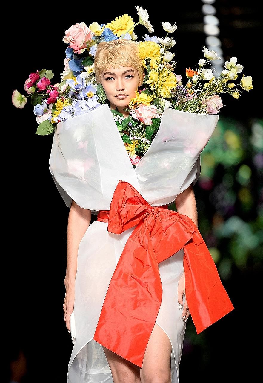 Model Gigi Hadid in a flowery creation from the Moschino Spring/ Summer 2018 show.