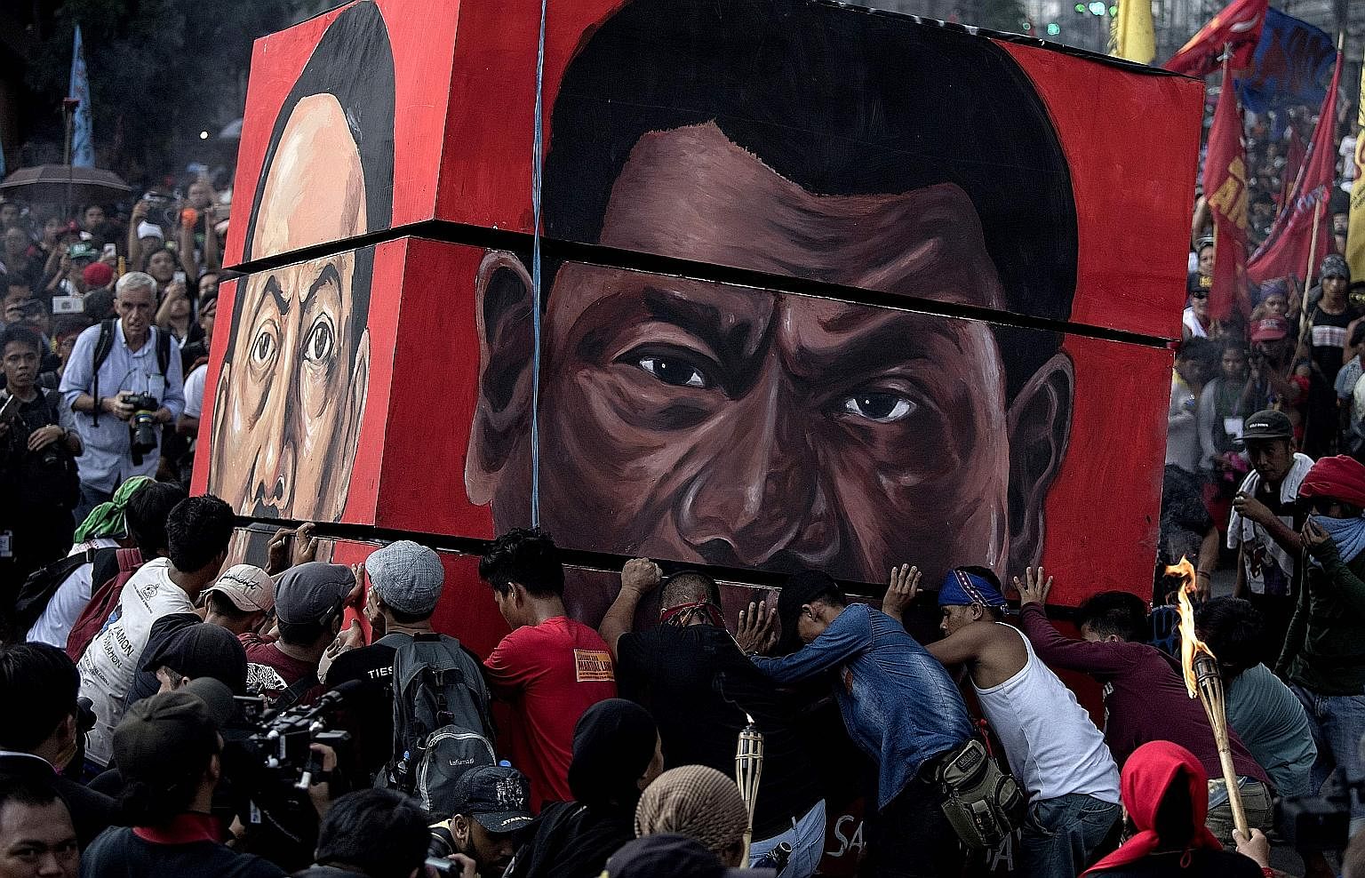 Activists preparing to burn a structure bearing the image of Philippine President Rodrigo Duterte during a protest against near Malacanang Palace in Manila on Sept 21. One reason his popularity is at its lowest since he took office in June last year 