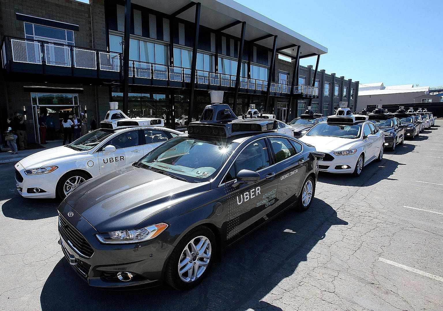 Uber's Ford Fusion self-driving cars at a demonstration event in Pittsburgh, Pennsylvania, last year. The transport tech company has reportedly agreed to partner General Motors' Cruise division on driverless technology.