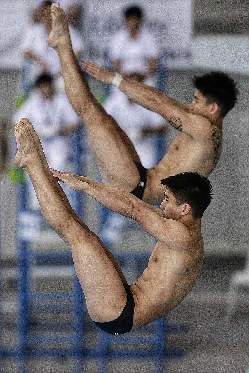 Timothy (front) and Mark Lee of Singapore in action during the Fina Diving Grand Prix's men's synchronised 3m springboard final at the OCBC Aquatic Centre yesterday.