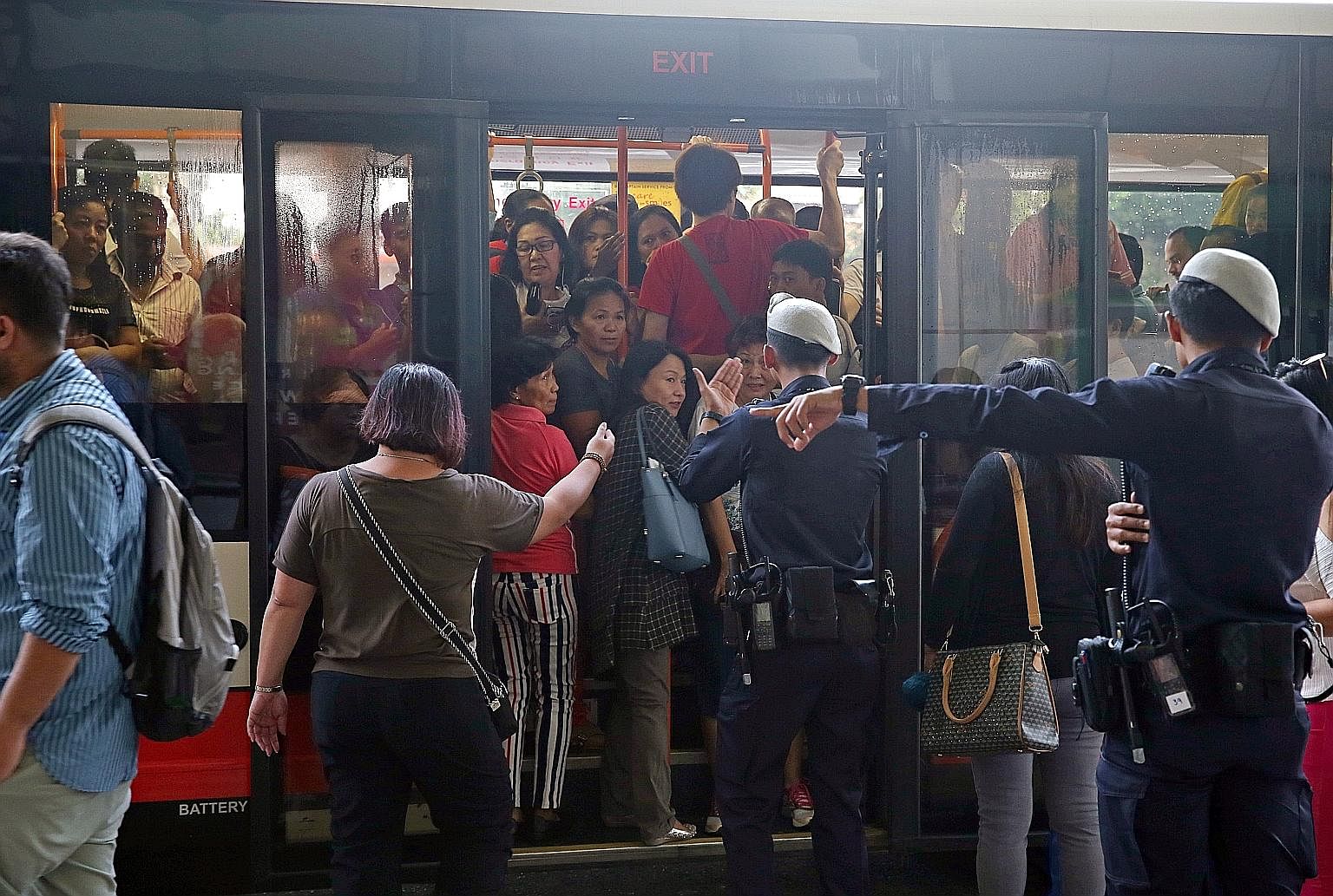Commuters using a bridging bus service at Bishan station after MRT service was disrupted by a flooded tunnel on the morning of Oct 8.