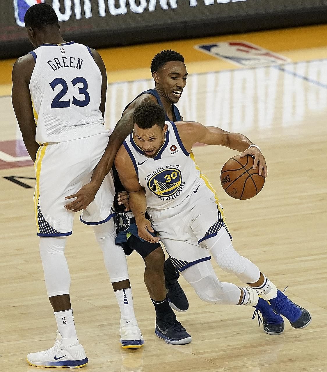 Golden State Warriors' Stephen Curry and team-mate Draymond Green executing a pick and roll to evade the defence of Minnesota Timberwolves guard Jeff Teague during their NBA game on Wednesday. Golden State won 125-101.