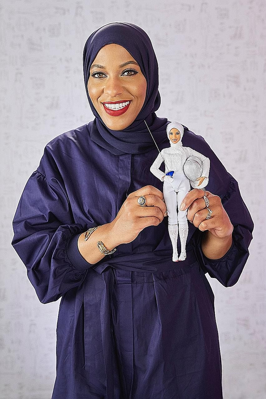 Olympic fencer Ibtihaj Muhammad with the Barbie doll modelled after her.