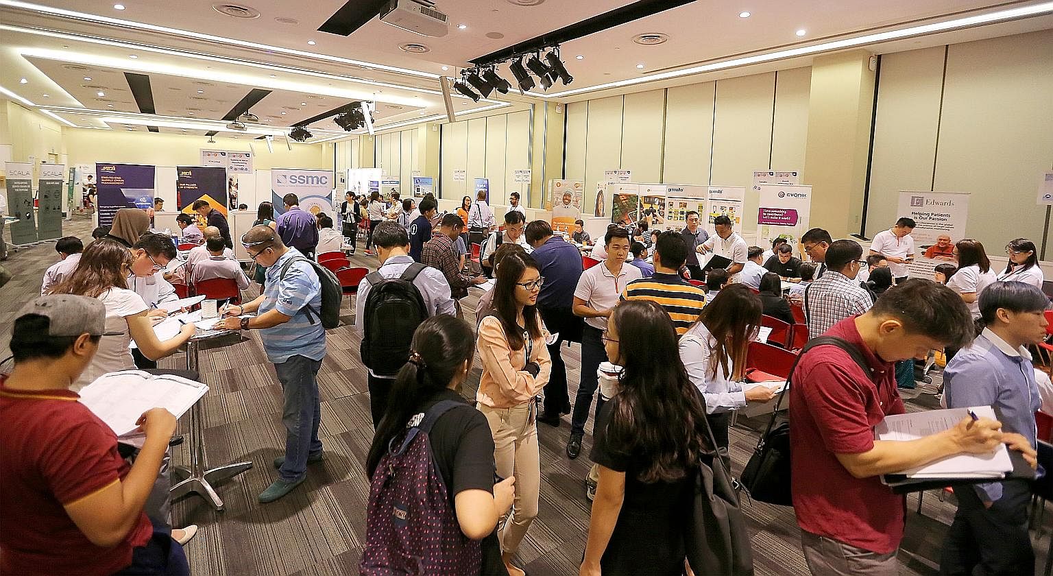 Job seekers at a career fair at the Devan Nair Institute for Employment and Employability earlier this year. The organisation also holds workshops to help those who want to brush up on resume-writing and interview skills.