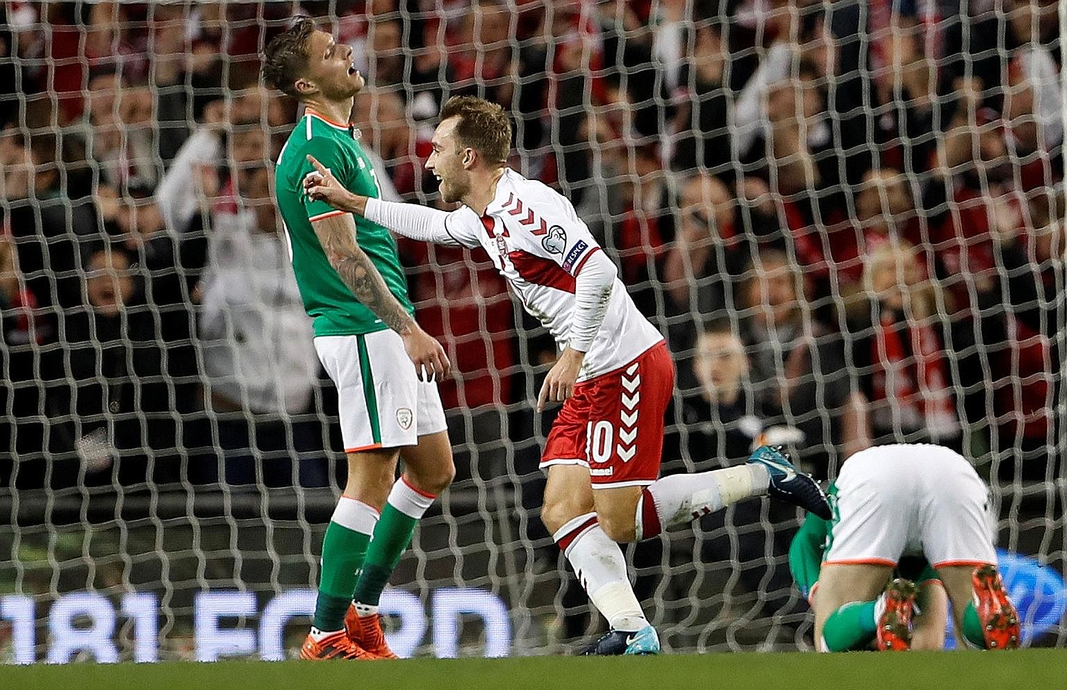 Denmark's delight is the Republic of Ireland's despair, as Christian Eriksen celebrates scoring their fourth goal to complete his hat-trick in the Danes' 5-1 victory in the World Cup play-off on Tuesday.