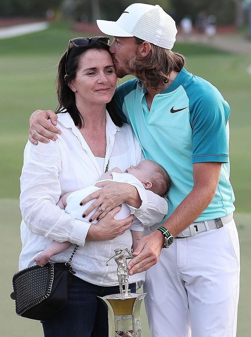 Tommy Fleetwood with his partner Clare Craig and their son Franklin, after winning the Race to Dubai trophy at the end of the DP World Tour Golf Championship at Jumeirah Golf Estates in Dubai yesterday.