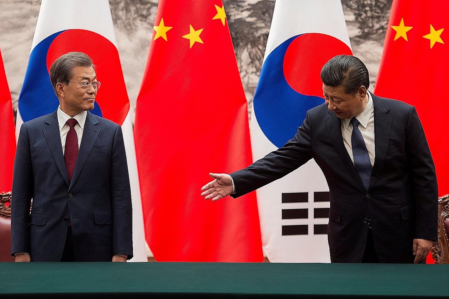 Chinese President Xi Jinping (right) with South Korean President Moon Jae In at a signing ceremony at the Great Hall of the People in Beijing on Thursday. The two leaders have pledged to improve bilateral ties and work to resolve the North Korean nuc