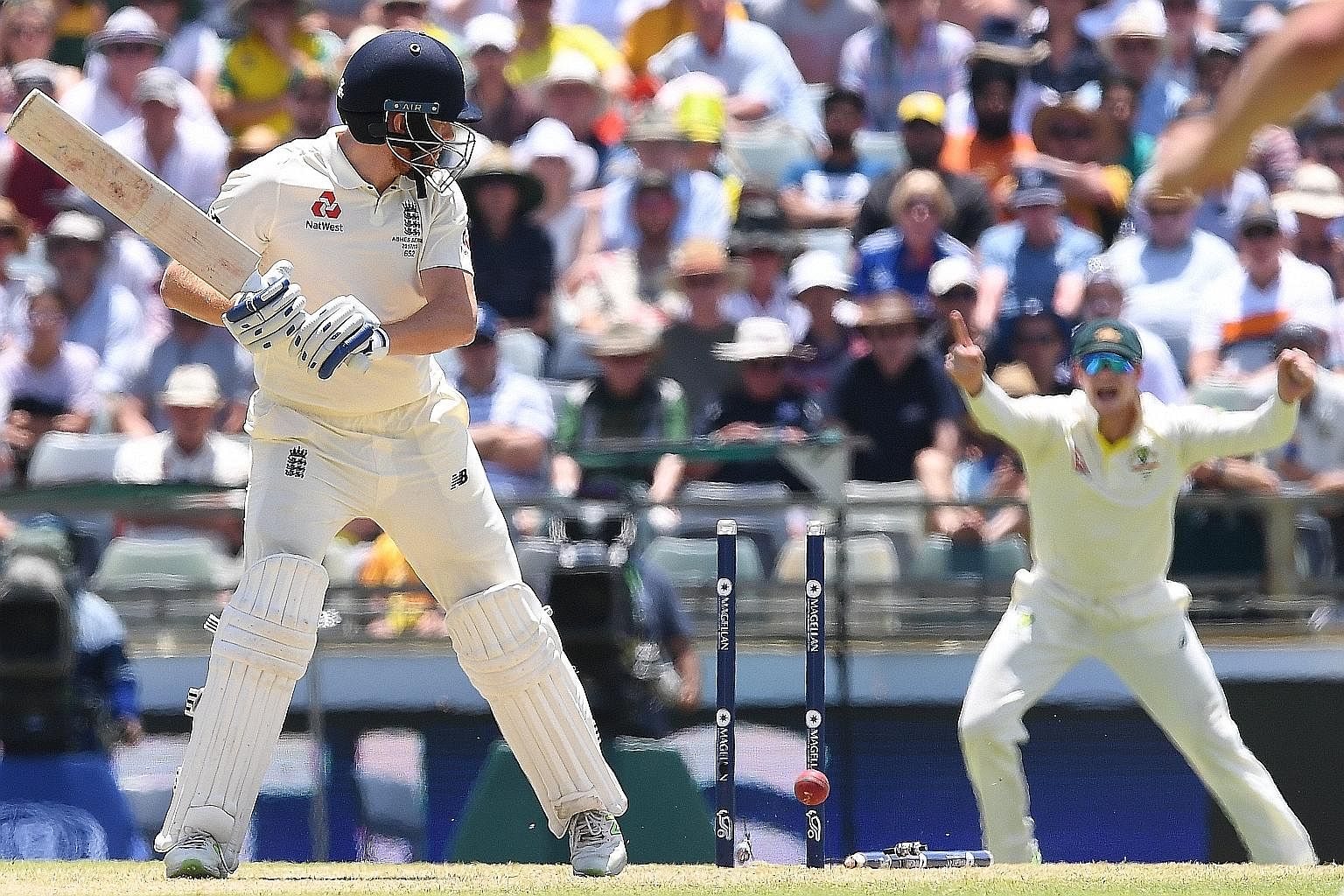Above: England's Jonny Bairstow loses his middle stump to Australia's Mitchell Starc during the third Ashes Test in Perth yesterday. 