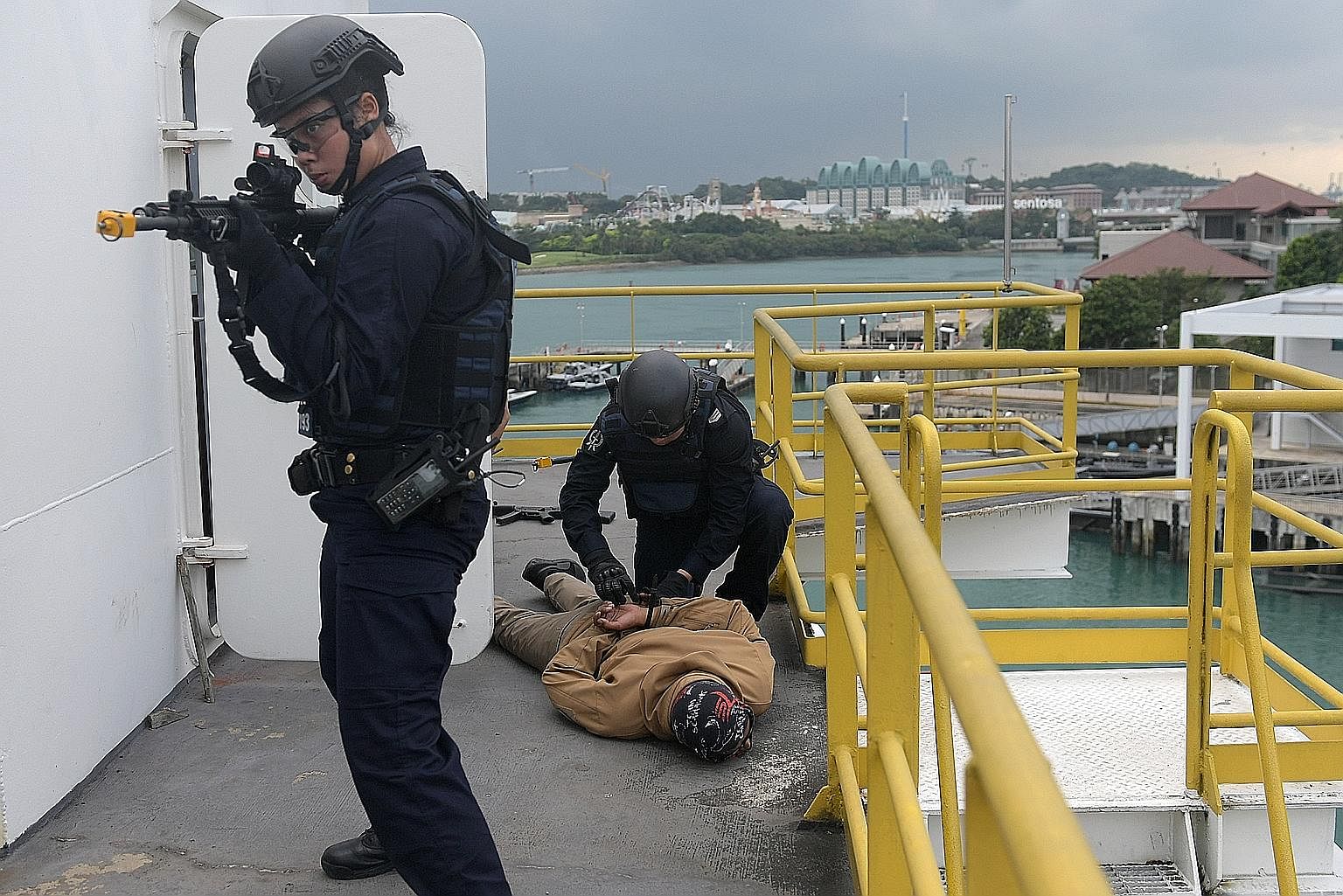 In an exercise on the Board and Search Trainer, Police Coast Guard Emergency Response Team officers stormed a room to locate a ship's crew. The team also looked for two suspicious men who had been reportedly sighted on the vessel by the ship's captai