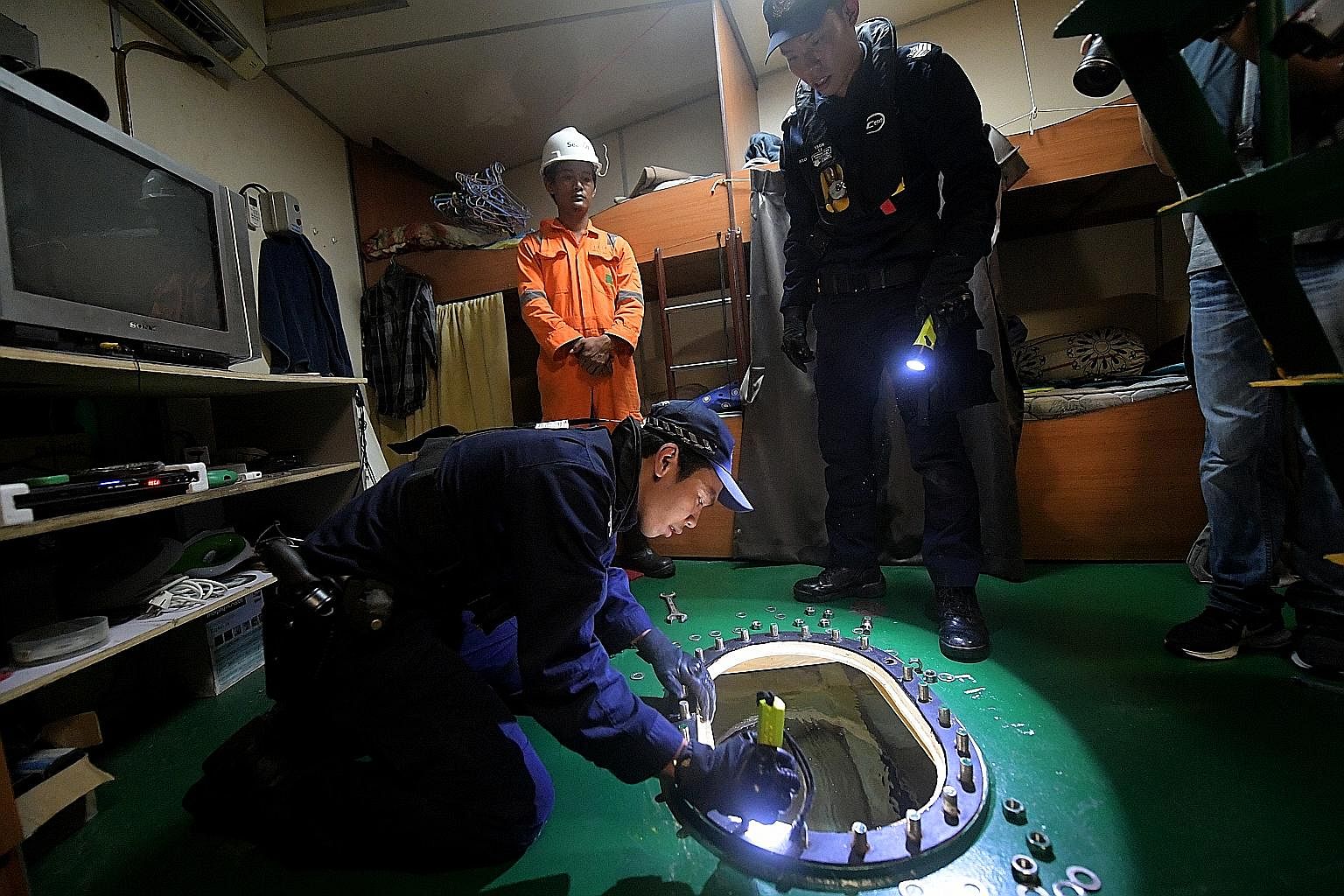 Police Coast Guard Anti-Smuggling Team officers inspecting a water tank for contraband or weapons during a surprise check on a vessel on Wednesday.