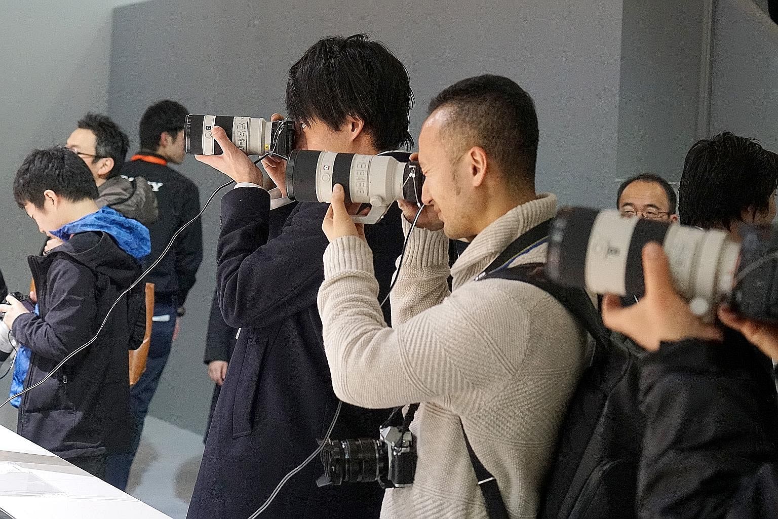 Visitors trying products at the CP+ Camera and Imaging Show in Yokohama in February.