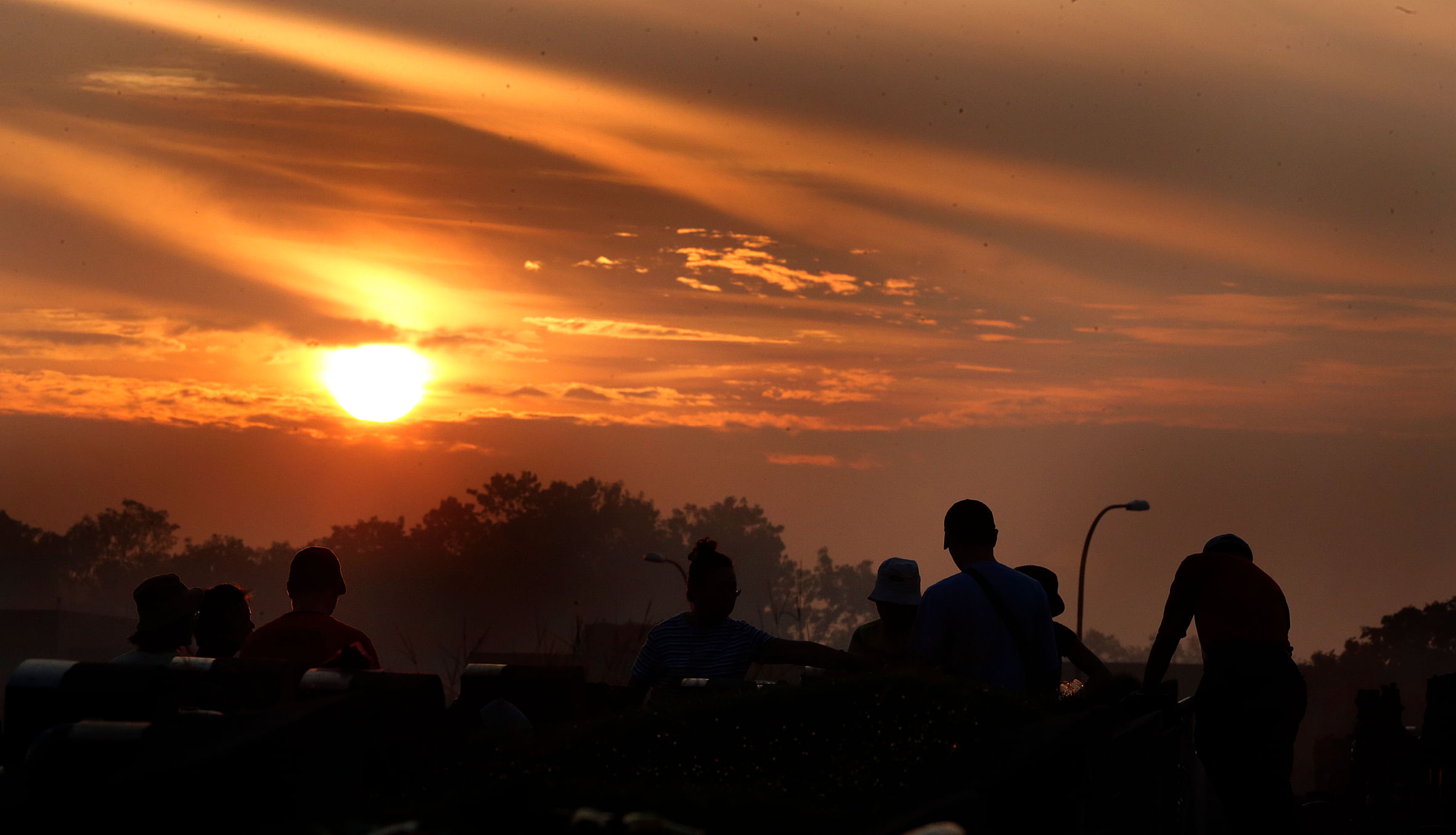 Families paying their respects at Choa Chu Kang Cemetery at dawn during a Qing Ming Festival, which is an annual “tomb sweeping” day. PHOTO: ST FILE