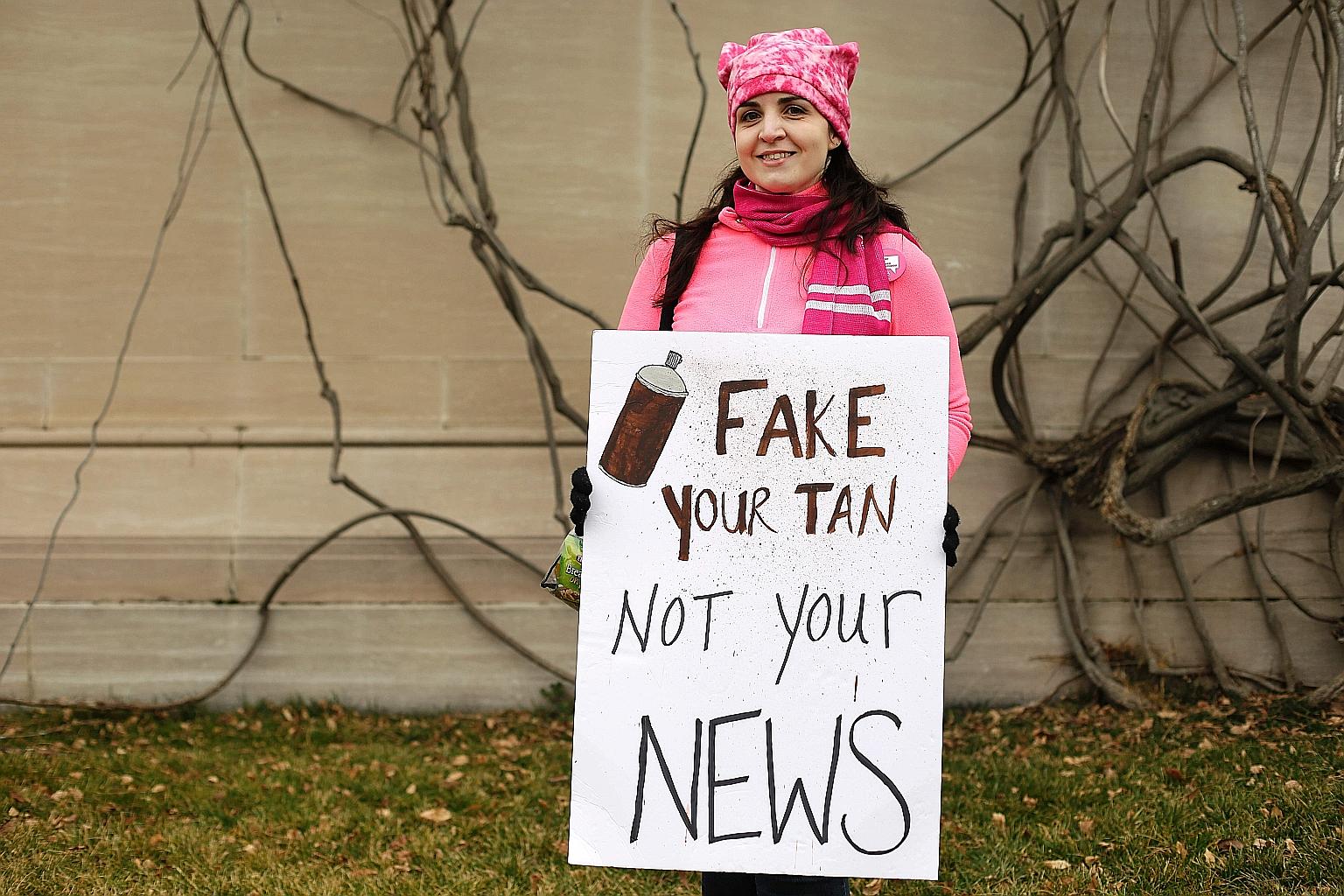A protester with a sign condemning "fake news" in Washington during last year's Women's March. US senators have proposed an Honest Ads Act to deal with political advertisements.