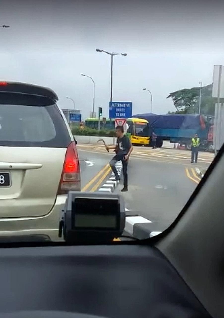 Videos posted online show the man wielding a sickle as uniformed officers approached him. The man was arrested after the 20-minute standoff.