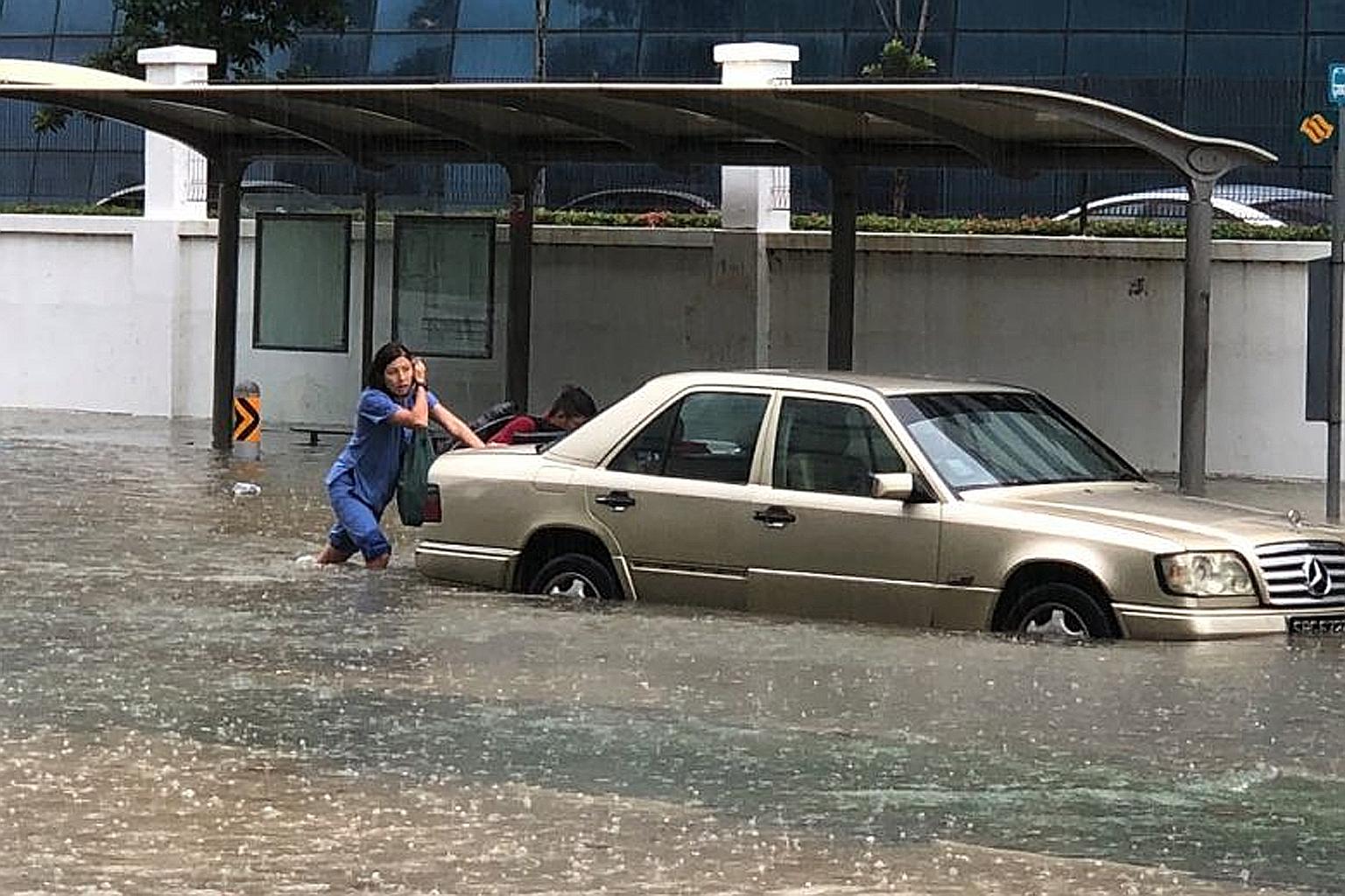 A car stranded along Upper Changi Road yesterday, one of nine areas in the east hit by flash floods. Drainage works taking place in eight of the affected areas are expected to be completed by March next year.
