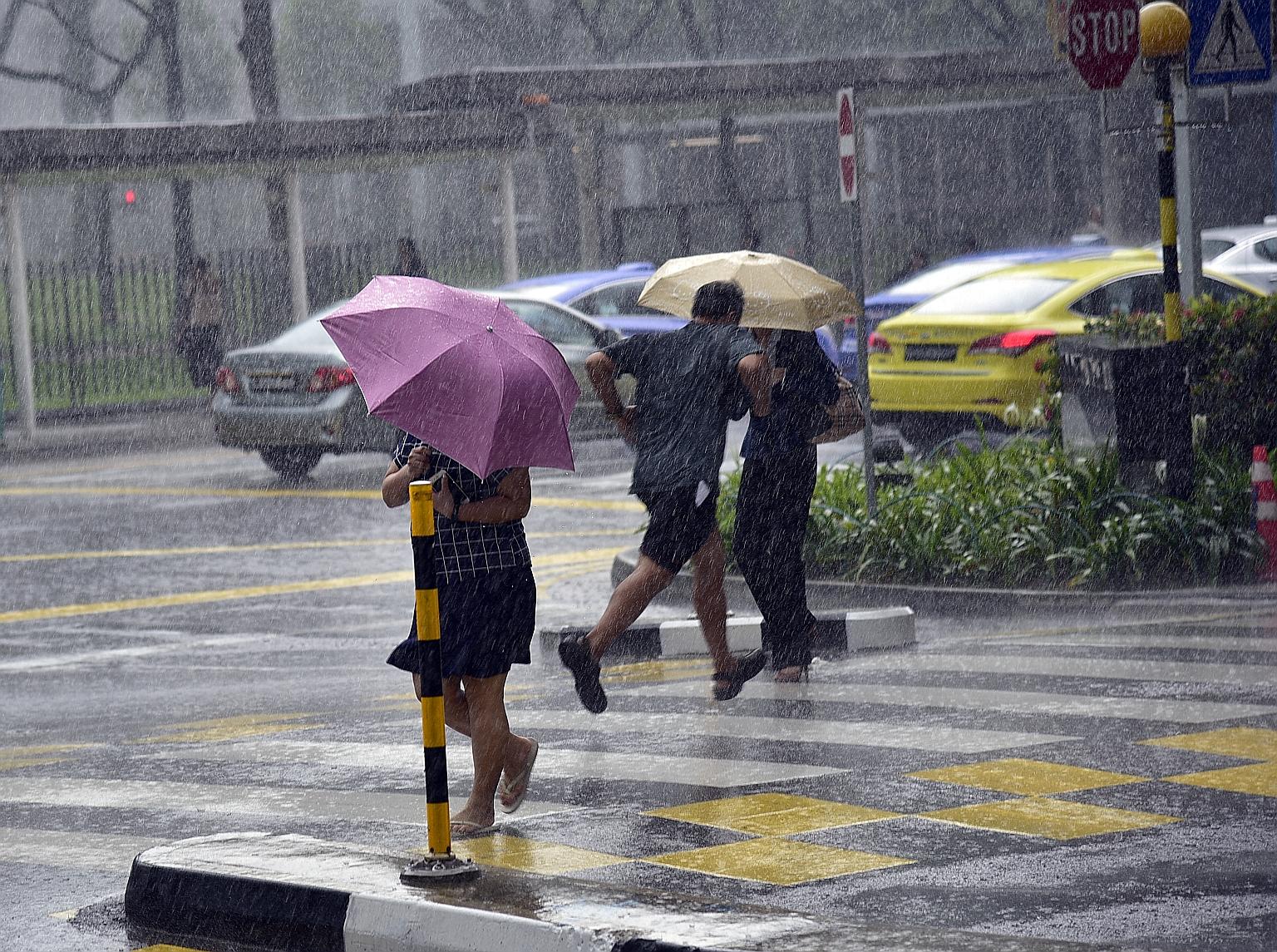 Heavy rain in North Bridge Road, near Peninsula Plaza, yesterday afternoon. There were thundery showers in areas like Bukit Merah, Clementi and Queenstown, and in the city.