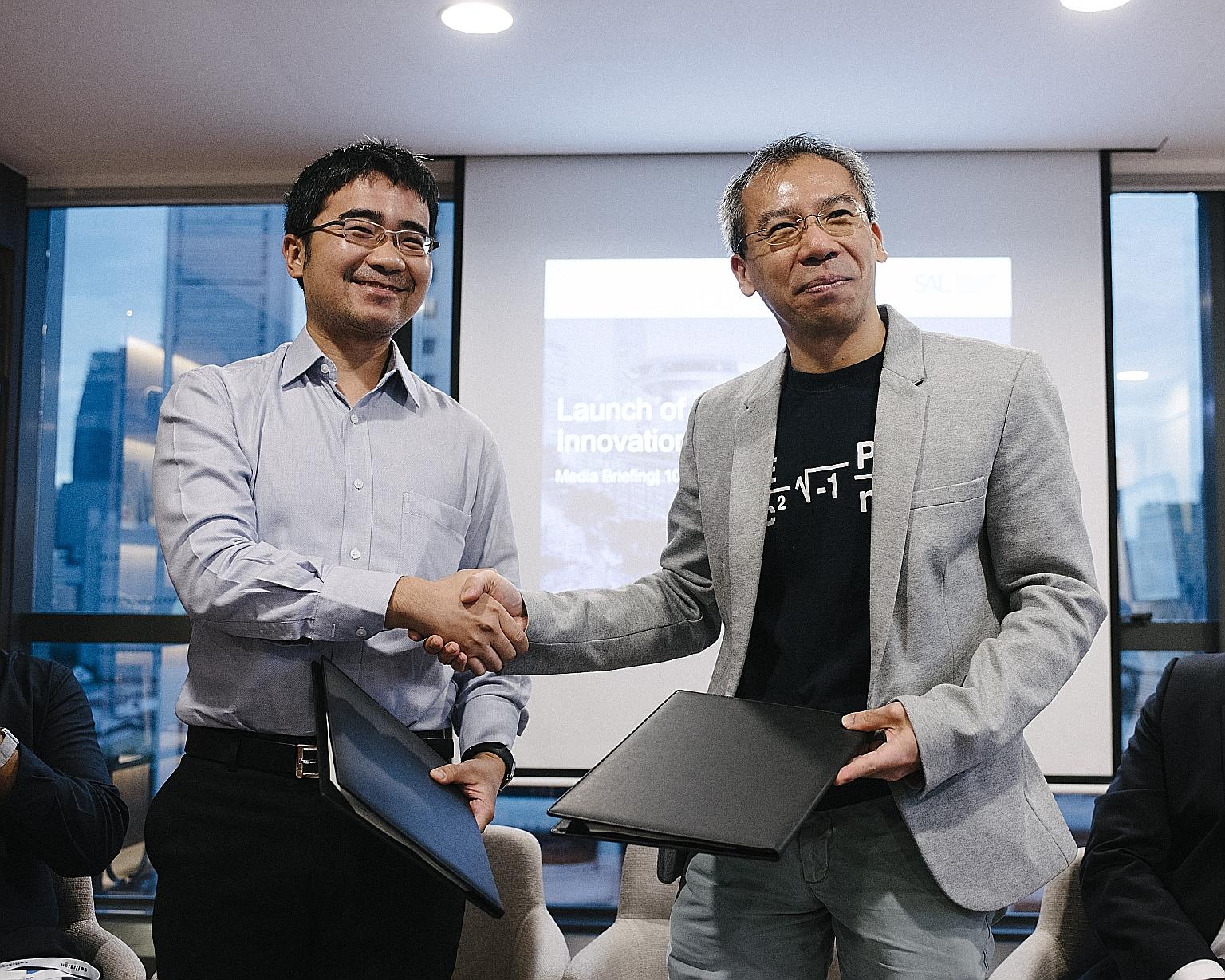 SMU law school dean Goh Yihan (far left) and SAL chief operating officer and chief financial officer Paul Neo at the signing of the memorandum of understanding yesterday.