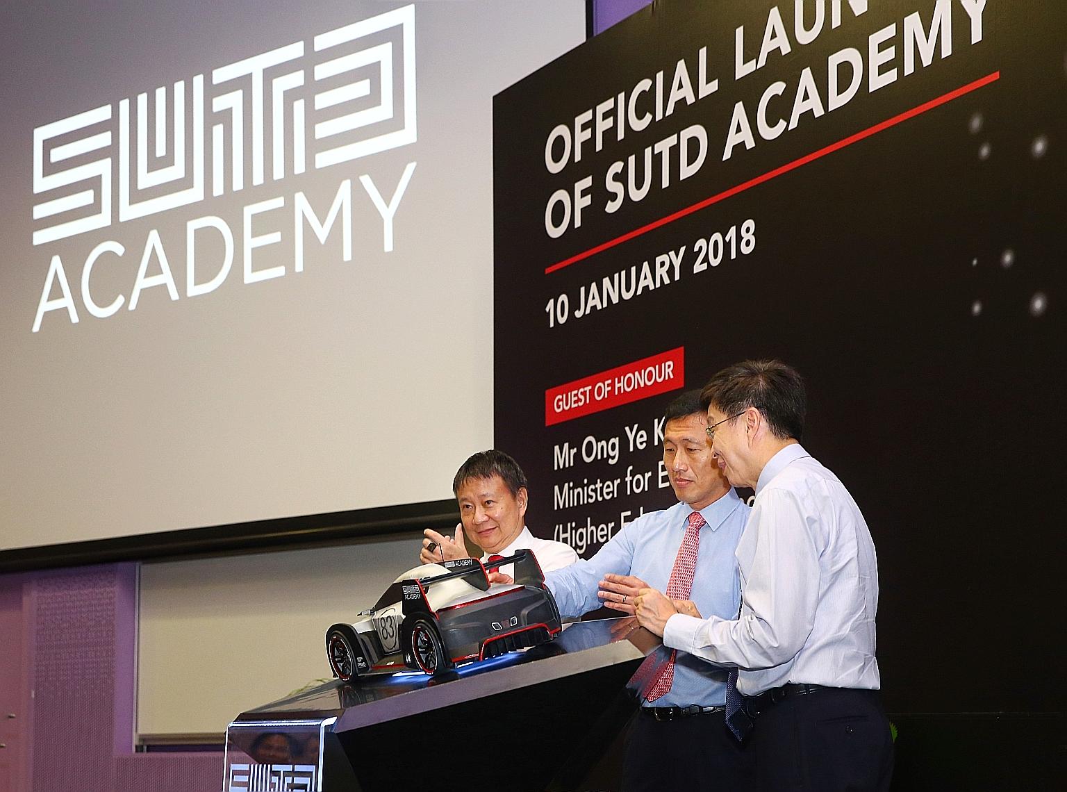 From far left: SUTD chairman Lee Tzu Yang, Education Minister (Higher Education and Skills) Ong Ye Kung and the university's acting president and provost Chong Tow Chong pressing a touchpad to officially launch SUTD Academy yesterday. The academy wil