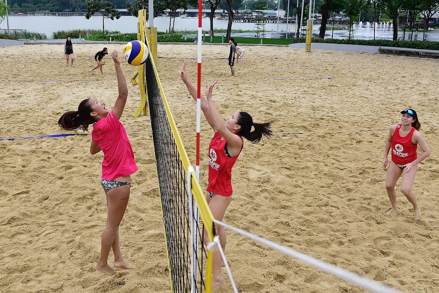 National beach volleyball players Serene Ng (left) and Vanessa Lim training at the Singapore Sports Hub even as temperatures hit lows of 22 deg C on Thursday. Six players are competing for two spots on the Commonwealth Games team, should the Singapor