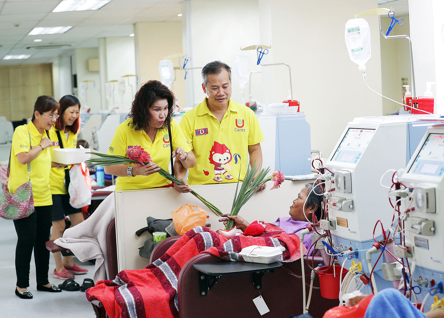 Ms Nancy Khoo and Mr Johnson Ong visiting Madam Ruhaya Mohd Noor, 58, who is receiving dialysis at the Kidney Dialysis Foundation.