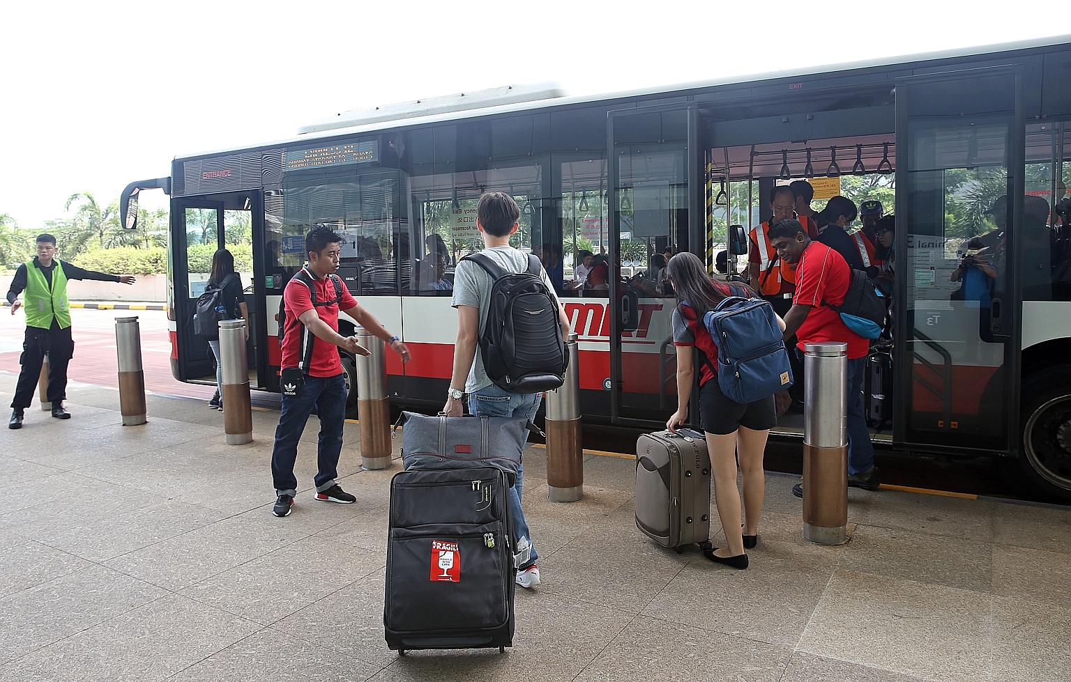 Travellers boarding a shuttle bus at Changi Airport Terminal 3 yesterday, when the Changi Airport MRT station was closed.