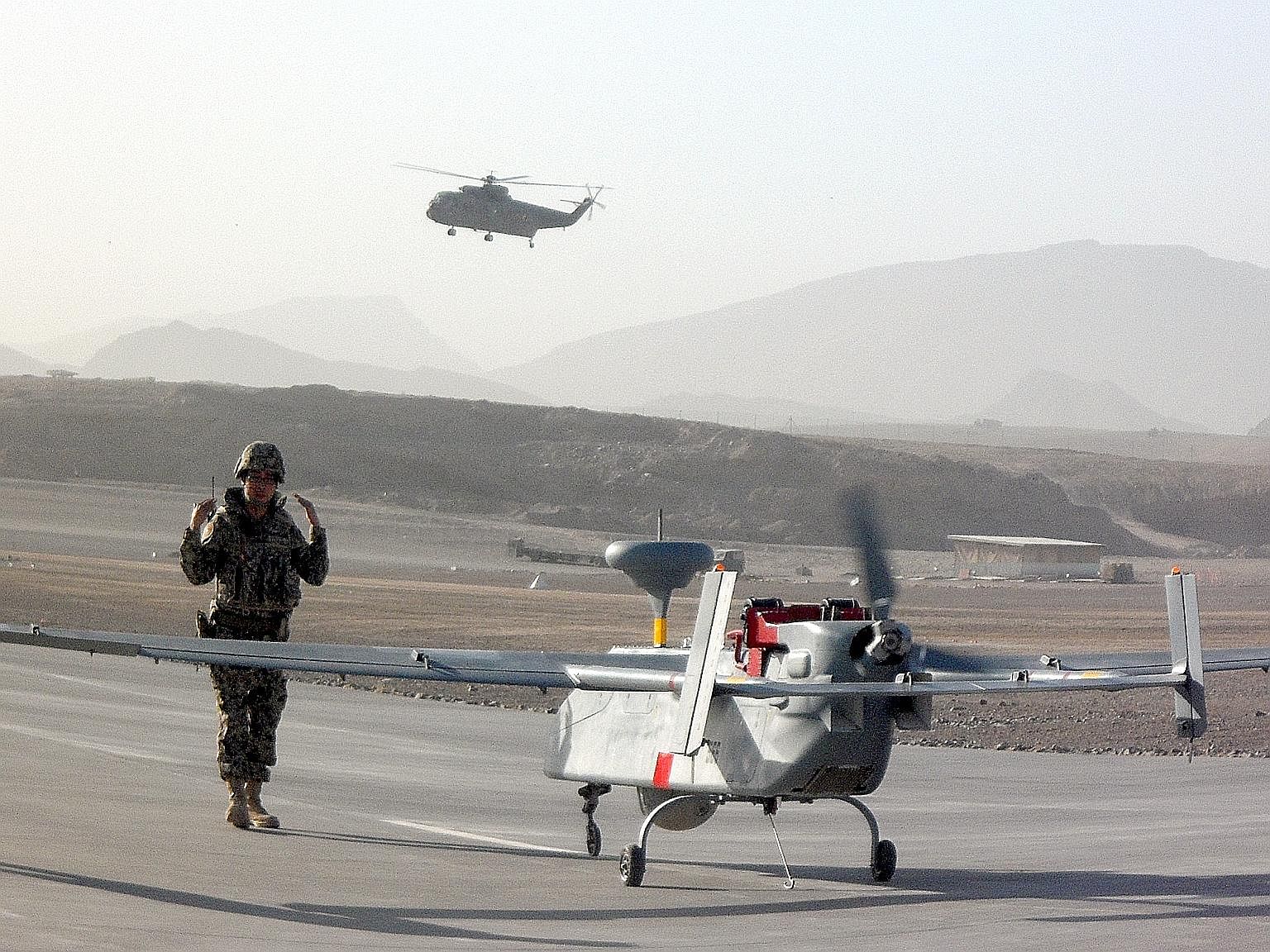A Searcher UAV being prepared for take-off in Afghanistan. The RSAF's UAV team, which was deployed in the war zone from August to November 2010, was tasked with providing surveillance and reconnaissance for international forces there.