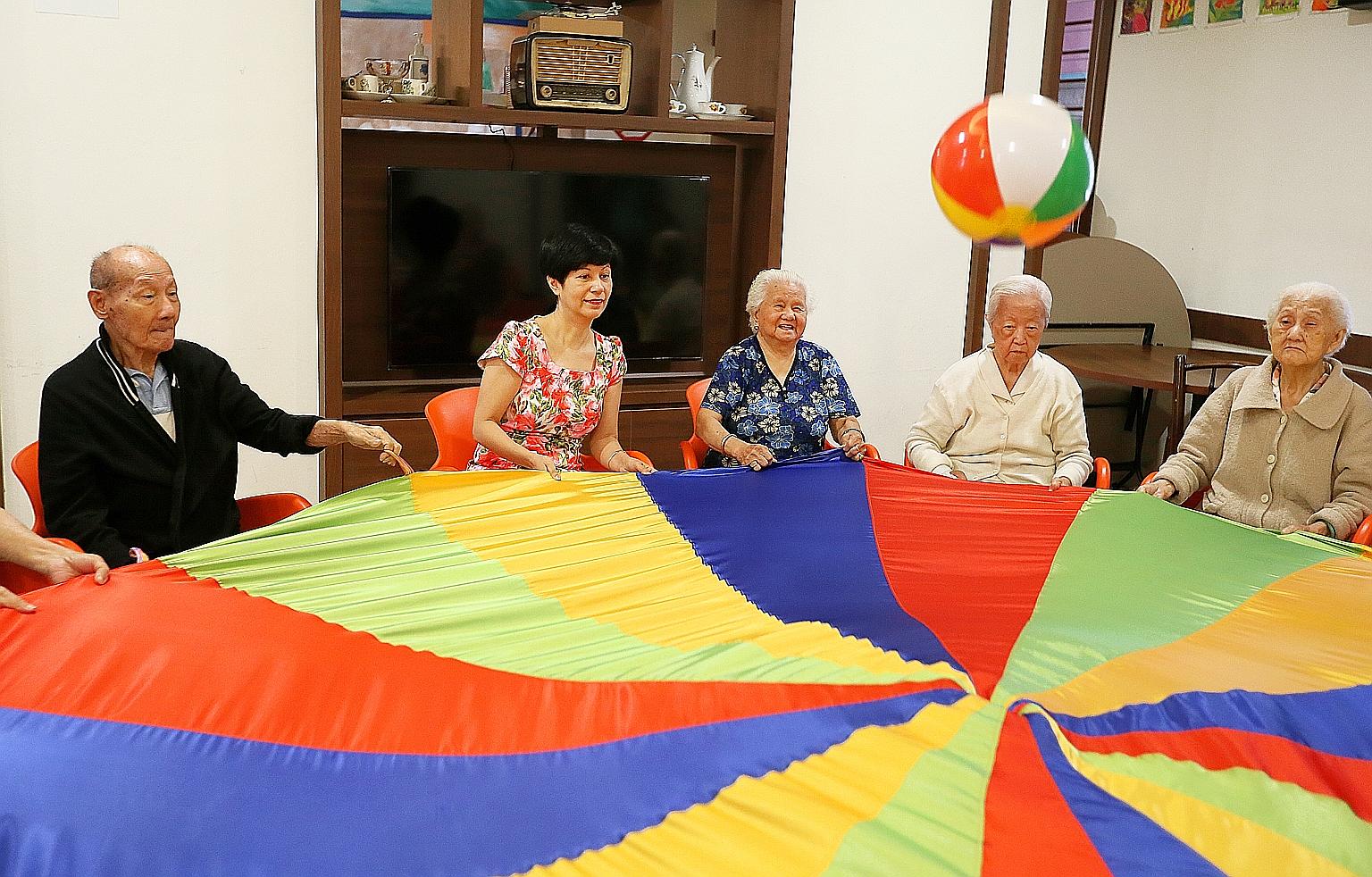 Senior Minister of State for Finance Indranee Rajah joining seniors in an activity at the Awwa Dementia Day Care Centre yesterday.