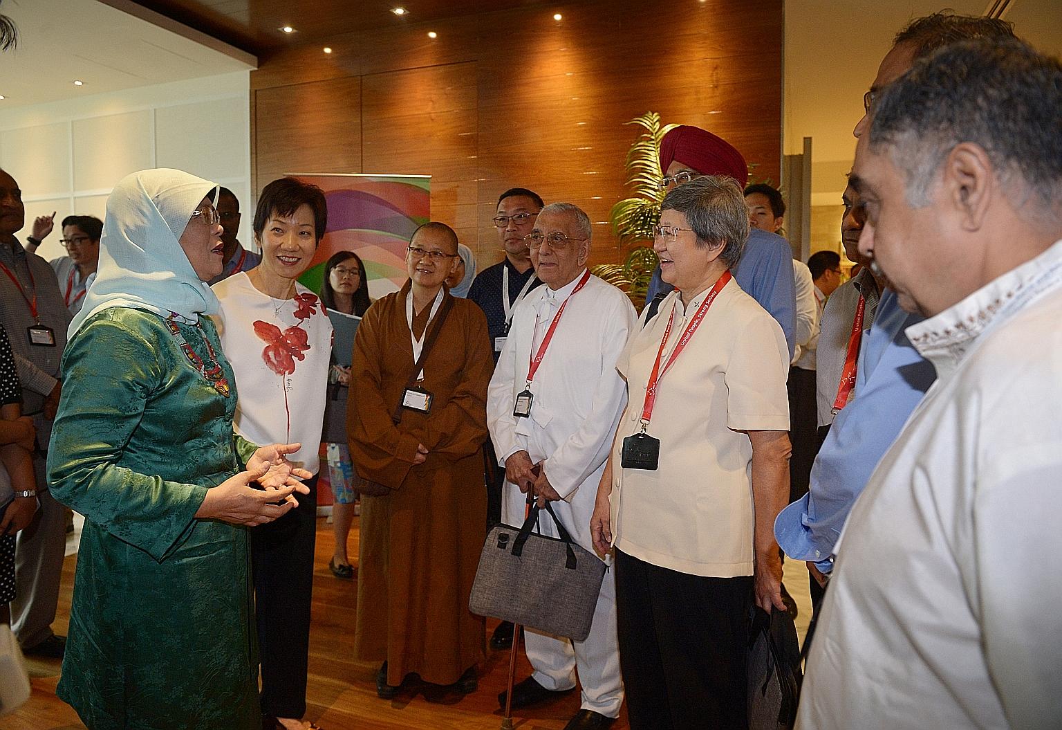 From left: President Halimah Yacob with Minister for Culture, Community and Youth Grace Fu and community and religious leaders, including Venerable Faxun, Mr Kenneth Ng (back row), Mr Rustom Ghadiali and Sister Maria Lau at the inaugural National Int