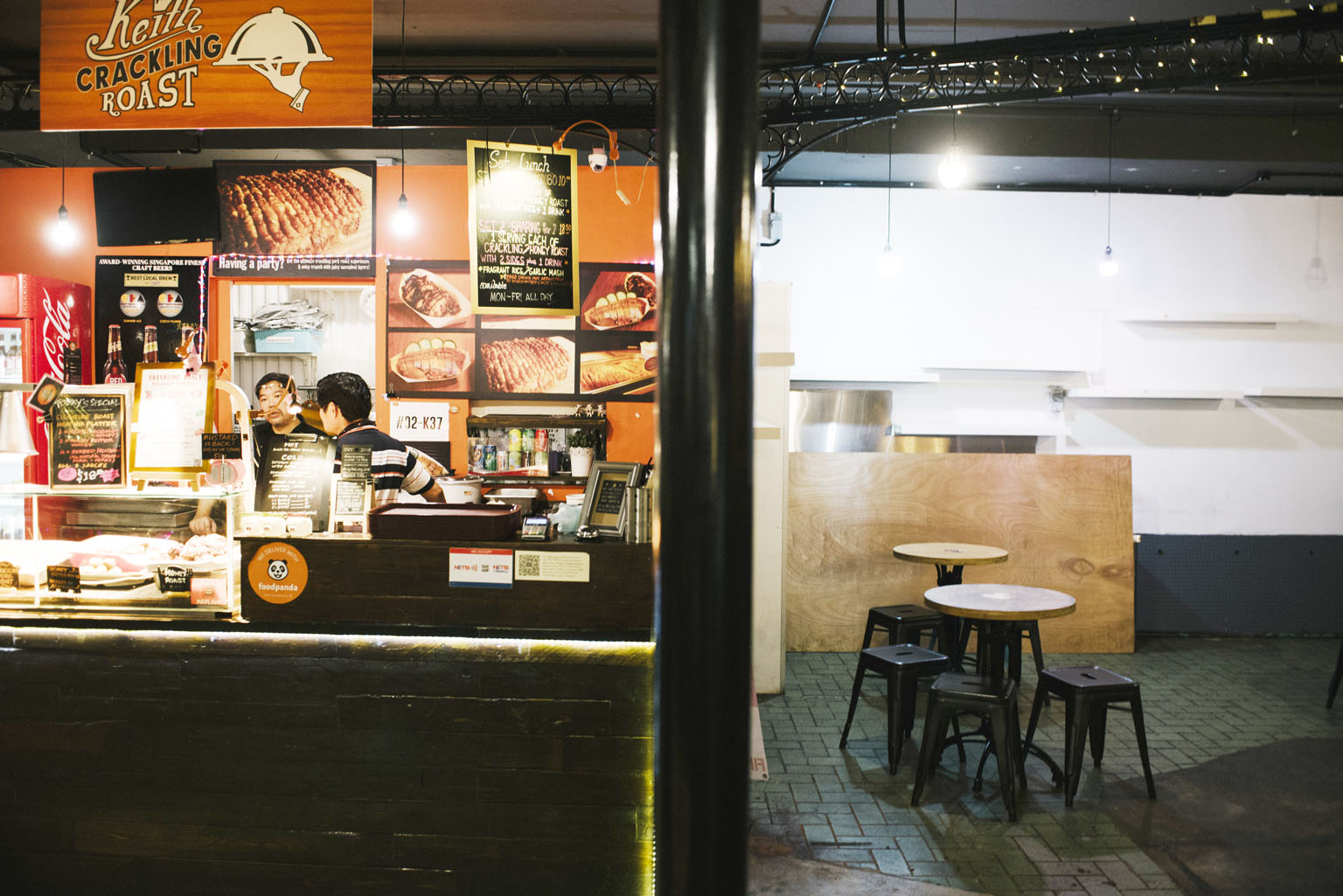 A food stall still in operation is adjacent to an already-shuttered outlet at PasarBella. The area once occupied by the closed outlet has been converted into extra seating space for customers.