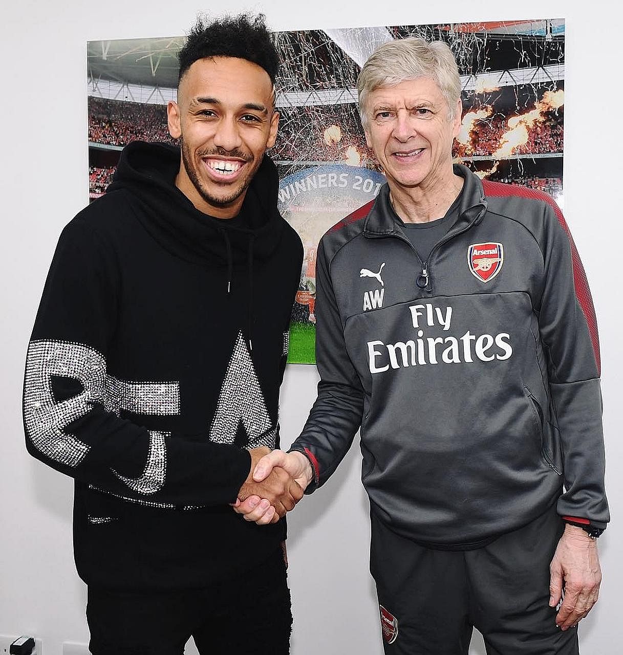 Pierre-Emerick Aubameyang being welcomed at Arsenal's training centre in London Colney by manager Arsene Wenger, who has singled out the striker's "huge physical capacity" as being important to his success in the Premier League.