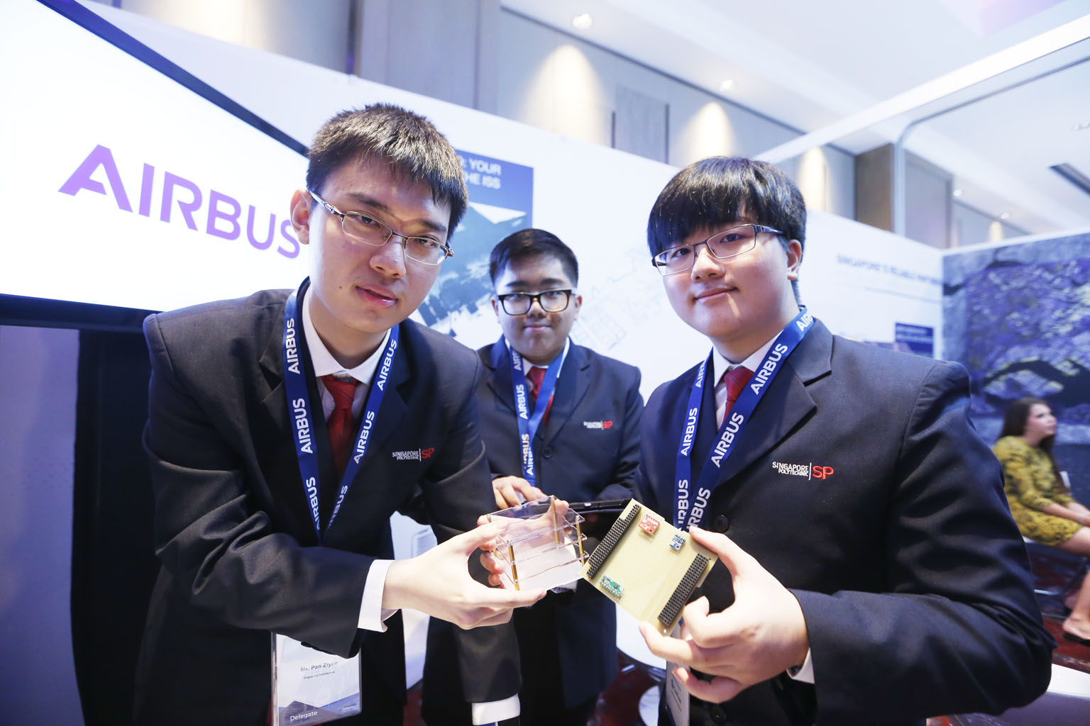 Singapore Polytechnic engineering students (from left) Pan Ziyue, Goh Qian Zhe and Julian Kang with a prototype cube satellite that they developed at the Global Space and Technology Convention at Sheraton Towers yesterday. The trio, who have their ow