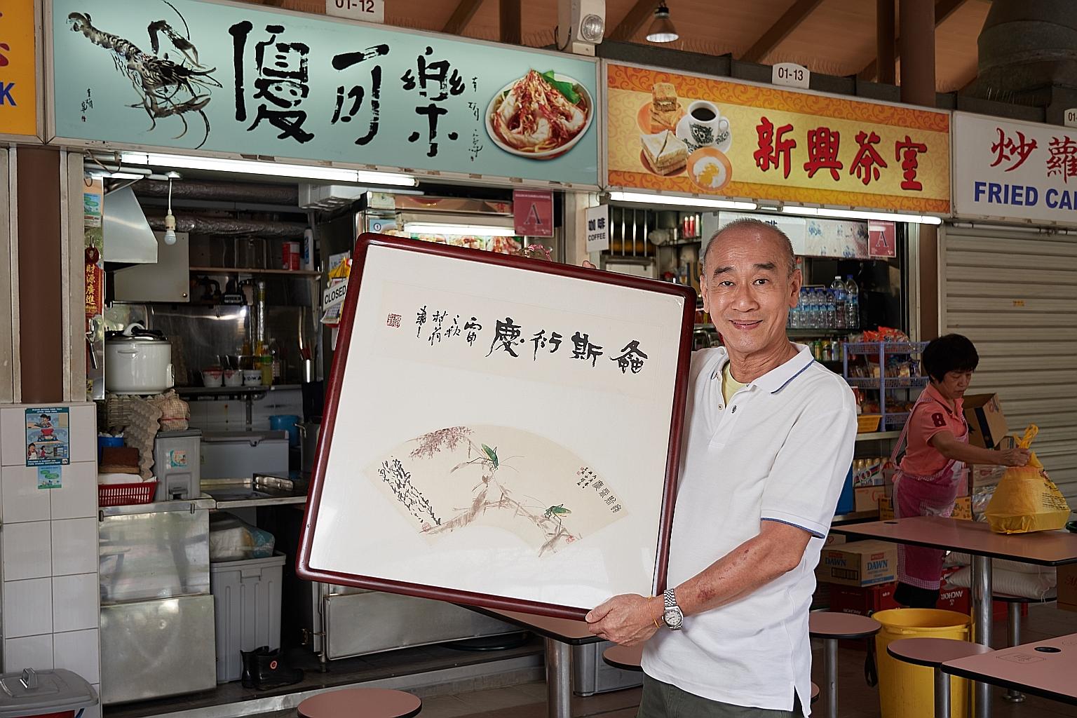Mr Tan Kin Chwee showing a calligraphy and painting artwork created by three artists - Chen Xiang, Wang Wing Seung and Chao Shao An - in front of his noodle stall in Sembawang Hills Food Centre. Mr Tan donated 44 of Chao's artworks to the Guangzhou M
