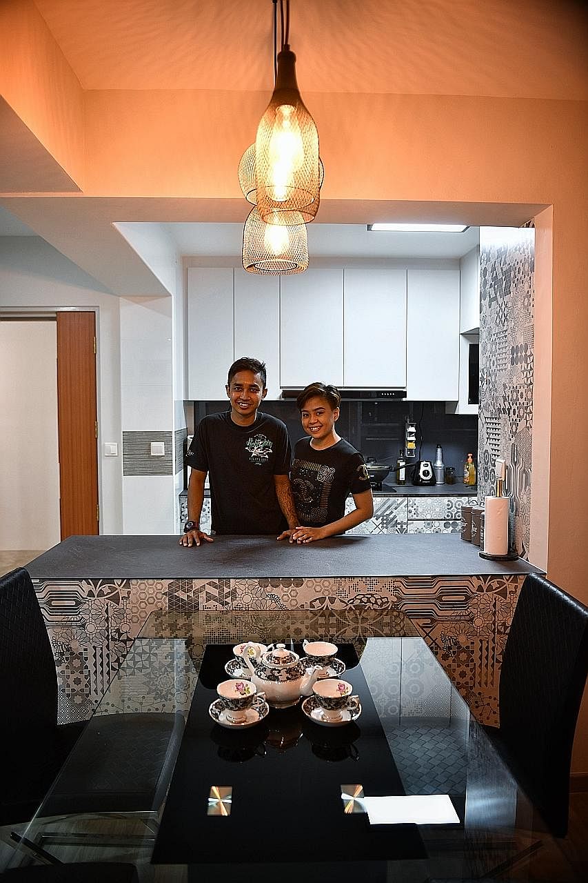 Home owners Khalit Sulaiman and Siti Norhaliz Salleh (above) spent about $8,000 on their open kitchen, including removing the wall separating the kitchen and the living room area and building a countertop.