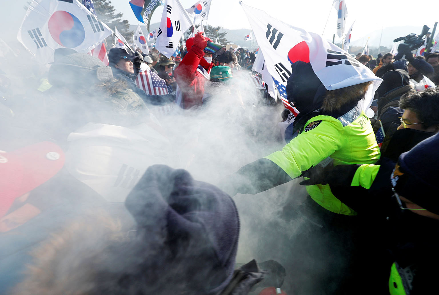 Police (in green) try to stop demonstrators during an anti-North Korea protest in Pyeongchang yesterday. Seoul is hoping this Winter Olympics will be a "Peace Olympics", though Washington and other parties are concerned that the games may be exploite