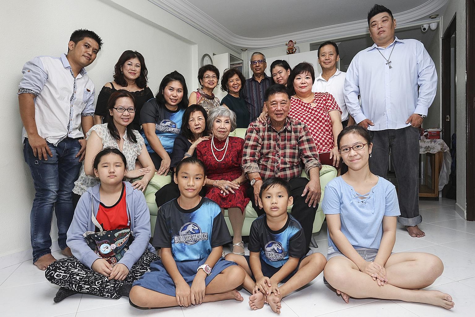 Matriarch of the Low family Tan Kim Yoke (centre) with some of her family members - including Ms Dora Low (back row, in dark green top), Ms Serena Low (third row, wearing Jurassic World T-shirt) and Umeko Yip (front row, in Jurassic World T-shirt) - 