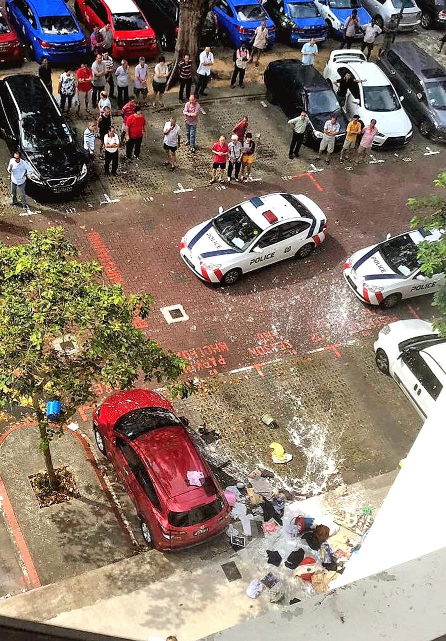 At least two cars in an HDB carpark were smeared with white paint yesterday after a man living on the fourth floor of a block threw household items and cans of paint down.