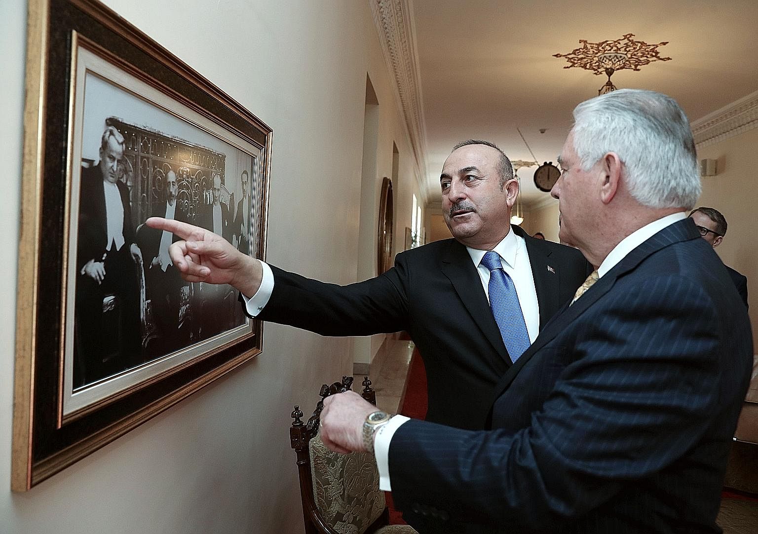 United States Secretary of State Rex Tillerson being shown a picture of the founder of modern Turkey, Mustafa Kemal Ataturk, by Turkish Foreign Minister Mevlut Cavusoglu last Friday. Mr Tillerson's main focus during his stopover in Ankara was the str