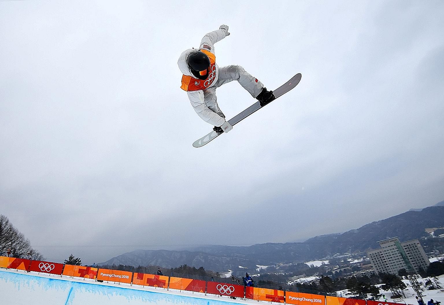 American Shaun White executing a move in the half-pipe final at Phoenix Snow Park on his way to a third Winter Olympics gold medal.