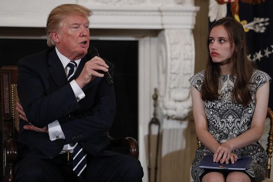 Student Carson Abt (right) listening to Mr Donald Trump at Wednesday's meeting.