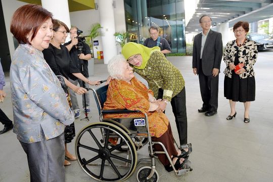 President Halimah Yacob greeting Mrs Urmila Nathan, widow of former president S R Nathan, at the Singapore University of Social Sciences yesterday, as Mrs Nathan's guest, businesswoman Jennie Chua (left), university president Cheong Hee Kiat (second